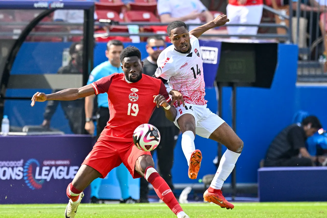 Canada midfielder Alphonso Davies (19) and Trinidad and Tobago defender Shannon Gomez (14) battle for control of the ball during the second half at Toyota Stadium.