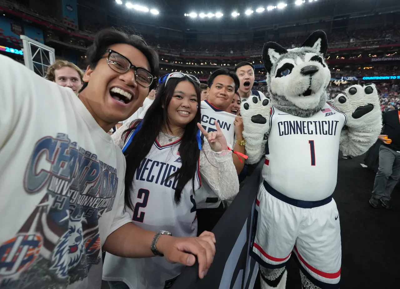 Purdue Boilermakers fans pose with the mascot before playing against the Purdue Boilermakers in the national championship game of the Final Four of the 2024 NCAA Tournament at State Farm Stadium.