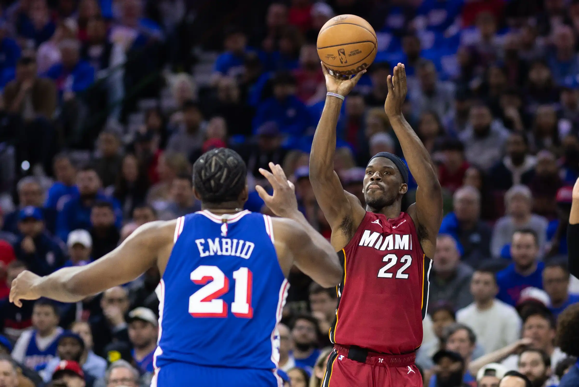 Miami Heat forward Jimmy Butler (22) shoots past Philadelphia 76ers center Joel Embiid (21) during the second quarter of a play-in game of the 2024 NBA playoffs at Wells Fargo Center.