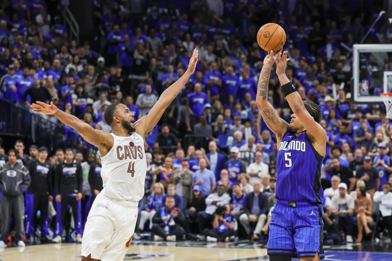 Orlando Magic forward Paolo Banchero (5) shoots the ball over Cleveland Cavaliers forward Evan Mobley (4) during the second half of game six of the first round for the 2024 NBA playoffs at Kia Center.