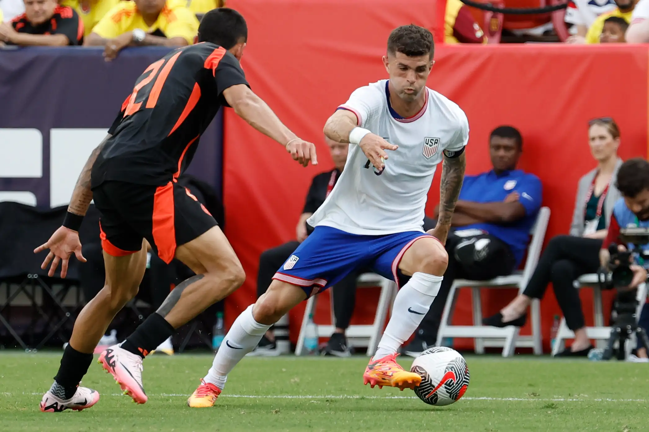 United States forward Christian Pulisic (10) dribbles the ball as Colombia defender Daniel Munoz (21) defends in the first half at Commanders Field.