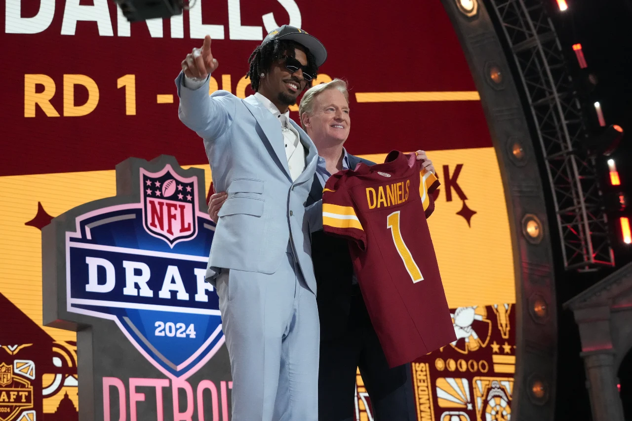 LSU Tigers quarterback Jayden Daniels poses with NFL commissioner Roger Goodell after being selected by the Washington Commanders as the No. 2 pick in the first round of the 2024 NFL Draft at Campus Martius Park and Hart Plaza.