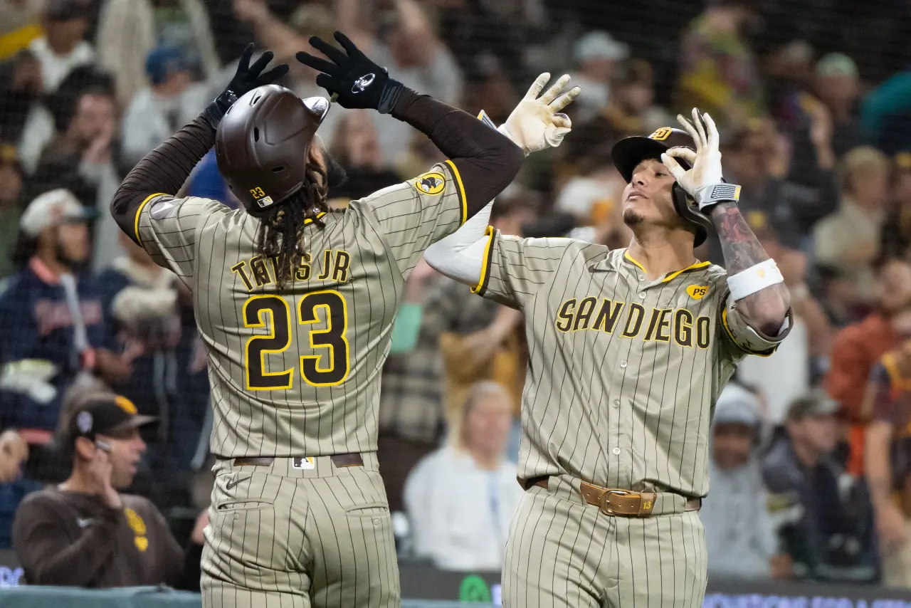 San Diego Padres right fielder Fernando Tatis Jr. (23) celebrates with third baseman Manny Machado (13) after hitting a solo home run during the seventh inning against the Seattle Mariners at T-Mobile Park.