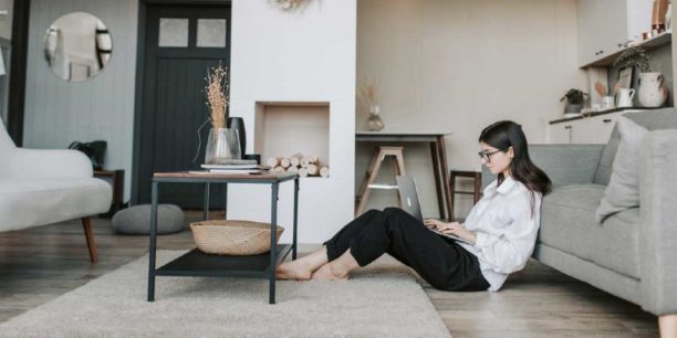 woman typing on the floor