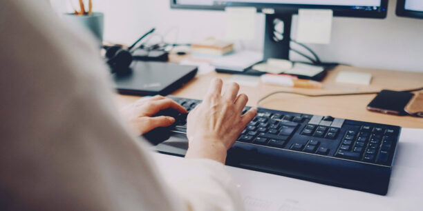 Woman typing on a keyboard