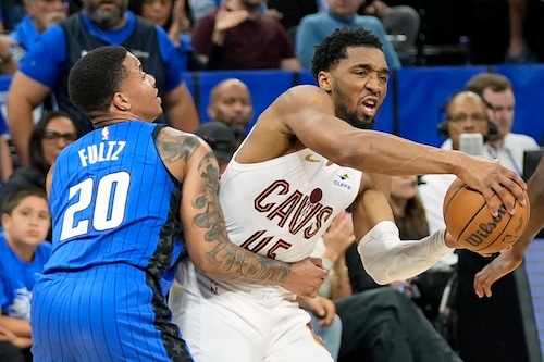 Cleveland Cavaliers guard Donovan Mitchell is fouled by Orlando Magic guard Markelle Fultz (20) as he tries to drives past him during the first half of Game 4 of an NBA basketball first-round playoff series, Saturday, April 27, 2024, in Orlando, Fla. (AP Photo/John Raoux)