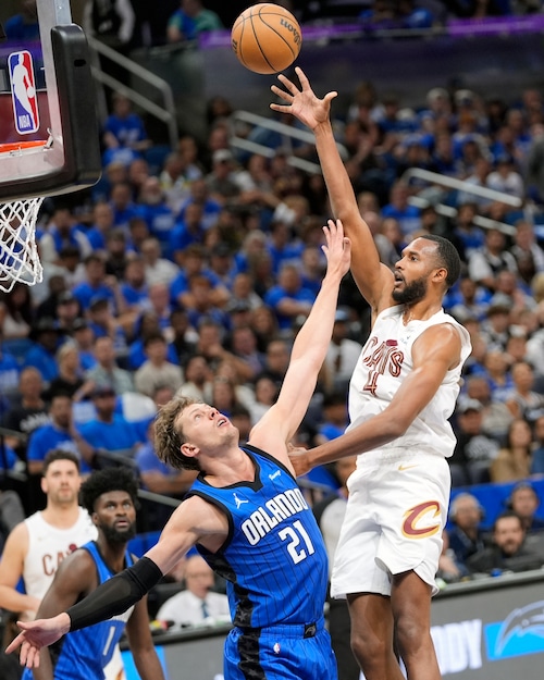 Cleveland Cavaliers forward Evan Mobley, right, shoots over Orlando Magic center Moritz Wagner (21) during the first half of Game 4 of an NBA basketball first-round playoff series, Saturday, April 27, 2024, in Orlando, Fla. (AP Photo/John Raoux)