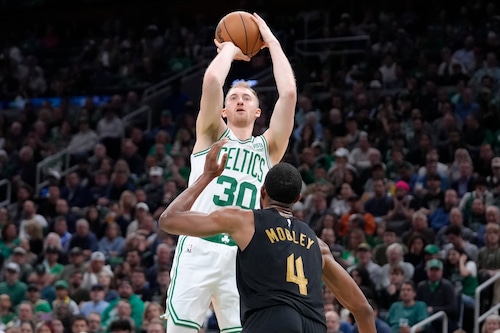 Boston Celtics forward Sam Hauser (30) shoots as Cleveland Cavaliers forward Evan Mobley (4) defends during the first half of Game 2 of an NBA basketball second-round playoff series Thursday, May 9, 2024, in Boston. (AP Photo/Steven Senne)