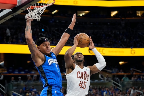 Cleveland Cavaliers guard Donovan Mitchell (45) is fouled by Orlando Magic forward Paolo Banchero, left, while attempting a shot during the first half of Game 4 of an NBA basketball first-round playoff series, Saturday, April 27, 2024, in Orlando, Fla. (AP Photo/John Raoux)