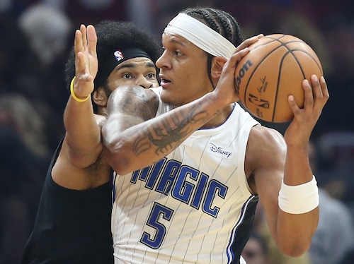 Magic forward Paolo Banchero looks for an outlet pass guarded tightly by Cleveland Cavaliers center Jarrett Allen in the first half