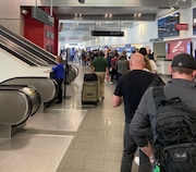 A long security line snakes through the terminal at Cleveland Hopkins airport on Sunday morning, May 5.