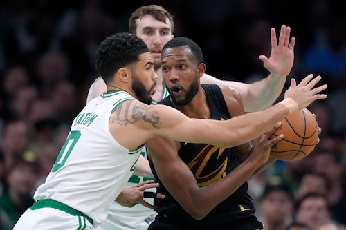 Cleveland Cavaliers forward Evan Mobley, right, is defended by Boston Celtics forward Jayson Tatum during the first half of Game 2 of an NBA basketball second-round playoff series Thursday, May 9, 2024, in Boston. (AP Photo/Steven Senne)
