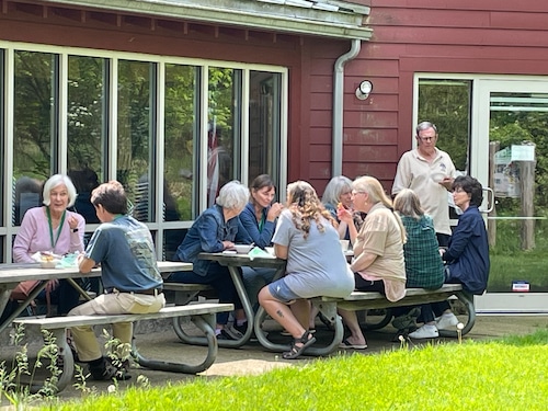 Folks sitting at picnic tables