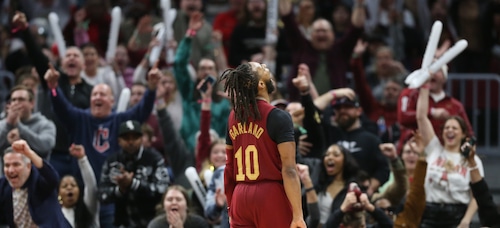 Cleveland Cavaliers guard Darius Garland (10) celebrates a turnover with Cavs fan of a Chicago Bulls turnover in the second half