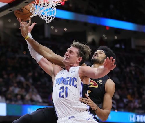 Orlando Magic center Moritz Wagner drives to the baskets for a layup attempt and is fouled by Cleveland Cavaliers center Jarrett Allen