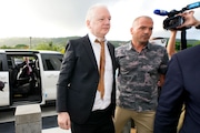 WikiLeaks founder Julian Assange, left, is escorted as he arrives at the United States courthouse where he is expected enter a plea deal, in Saipan, Mariana Islands, Wednesday, June 26 2024. (AP Photo/Eugene Hoshiko)