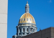FILE -  The gold dome of the State Capitol is shown on Wednesday, Feb. 14, 2024, in downtown Denver. A report published this week, Friday, June 14, by a Native American-led nonprofit examines in detail the dispossession of $1.7 trillion worth of Indigenous homelands in Colorado by the state and the U.S. and the more than $546 million the state has reaped in mineral extraction from them.  (AP Photo/David Zalubowski, File)