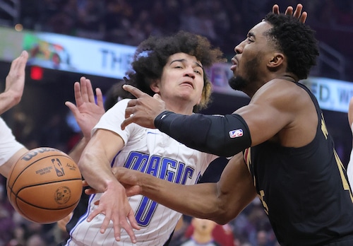 Cleveland Cavaliers guard Donovan Mitchell loses control of the basketball from the defense of Orlando Magic guard Anthony Black