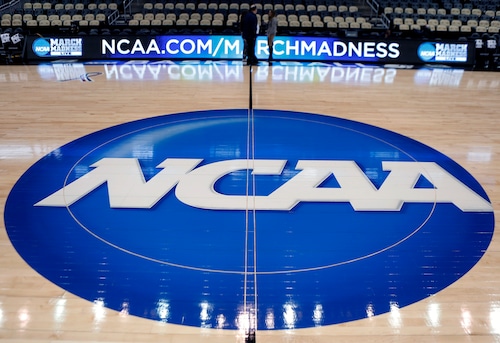 FILE - In this March 18, 2015, file photo, the NCAA logo is displayed at center court at The Consol Energy Center in Pittsburgh. The NCAA will hold the inaugural 32-team Women’s Basketball Invitation Tournament next spring on campus sites with the champion crowned April 3 in Indianapolis. ESPN-plus will televise the games exclusively. Westwood One Sports will provide radio coverage of the semifinals and finals. (AP Photo/Keith Srakocic, File)