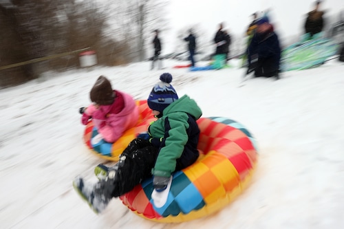 Families enjoy sledding of the freshly-fallen snow at the Huntington Reservation in Bay Village.