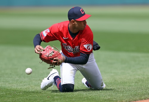 Cleveland Guardians shortstop Brayan Rocchio bobbles the throw to first giving Oakland Athletics second baseman Zack Gelof a single in the sixth inning.