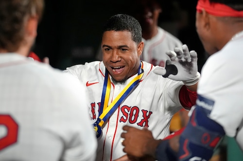 Enmanuel Valdez, center, celebrates with teammates