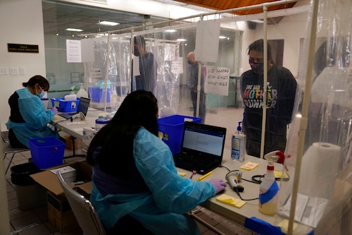 Workers at COVID testing site