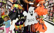 A child runs to keep up with her mom past items displayed and for sale at a shop selling Halloween goods in Alhambra, California on October 21, 2016. 
According to the National Retail Federation more than 171 million Americans will celebrate Halloween this year, with total spending expected to reach $8.4 billion, an all-time high in the history of NRF's annual survey conducted by Prosper Insights. / AFP / Frederic J. BROWN        (Photo credit should read FREDERIC J. BROWN/AFP via Getty Images)