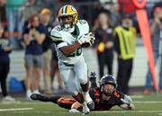 St. Edward’s Brandon White makes a catch before running for a touchdown against Massillon in the first half of play. 