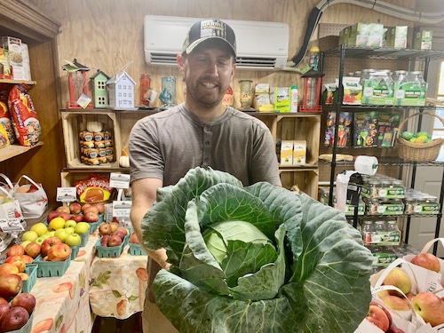 Ben Richardson holding a huge head of cabbage