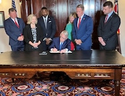 Gov. Mike DeWine signs House Bill 2, which funds $4.2 billion in state capital projects, while surrounded by other state leaders during a ceremony on Friday, June 28, 2024 in the governor's ceremonial office.