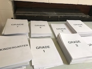 Lesson packets sit on a table at Cleveland's Marion Sterling elementary school for students to pick up as they collect free lunch and breakfast during Ohio's coronavirus school closures. (Patrick O'Donnell/The Plain Dealer)