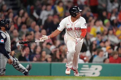 Rafael Devers drops his bat after hitting a two-run double