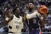 United States' forward LeBron James, right, goes for the basket as South Sudan's forward JT Thor defends during an exhibition basketball game between the United States and South Sudan, at the o2 Arena in London, Saturday, July 20, 2024. (AP Photo/Kin Cheung)