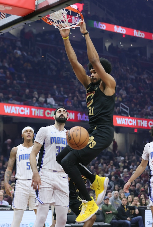 Cleveland Cavaliers center Jarrett Allen dunks the basketball for a score as Orlando Magic center Goga Bitadze can only watch the play