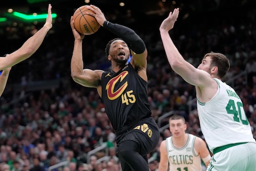 Cleveland Cavaliers guard Donovan Mitchell (45) shoots as Boston Celtics center Luke Kornet (40) defends during the second half of Game 2 of an NBA basketball second-round playoff series Thursday, May 9, 2024, in Boston. (AP Photo/Steven Senne)