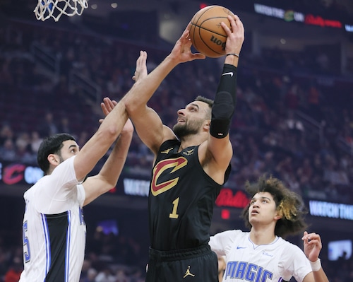 Cleveland Cavaliers guard Max Strus drives to the basket for a score guarded by Orlando Magic center Goga Bitadze