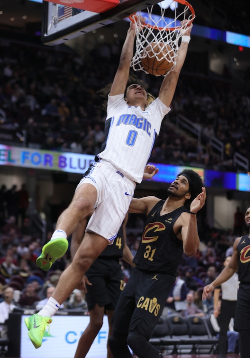 Orlando Magic guard Anthony Black dunks the ball defended by Cleveland Cavaliers center Jarrett Allen