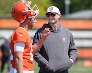 Cleveland Browns offensive coordinator Ken Dorsey talks with quarterback Jacob Sirman during the first day of rookie minicamp in Berea.