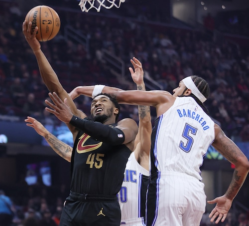 Cleveland Cavaliers guard Donovan Mitchell is hit in the head by the arm of Orlando Magic forward Paolo Banchero on a drive to the basket