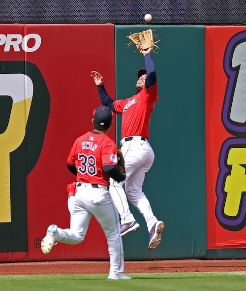 Cleveland Guardians center fielder Ramon Laureano goes up to catch a fly ball from Oakland Athletics catcher Shea Langeliers in the sixth inning.