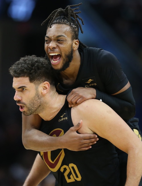 Cleveland Cavaliers guard Darius Garland jumps on the back of Cleveland Cavaliers forward Georges Niang celebrating Niang’s three-point score in the second half