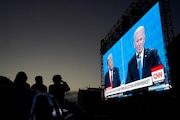 FILE - People watch from their vehicle as President Donald Trump, on left of video screen, and Democratic presidential candidate former Vice President Joe Biden speak during a Presidential Debate Watch Party at Fort Mason Center in San Francisco, Thursday, Oct. 22, 2020. Unflattering portraits of both Biden and Trump emerge clearly in a new poll by The Associated Press-NORC Center for Public Affairs Research, which asked an open-ended question about what comes to mind when people think of them. (AP Photo/Jeff Chiu, File)