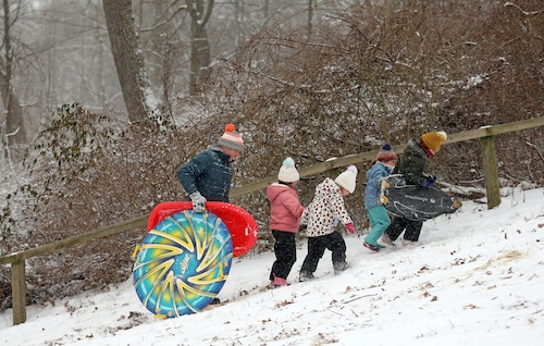 Families enjoy sledding of the freshly-fallen snow at the Huntington Reservation in Bay Village.