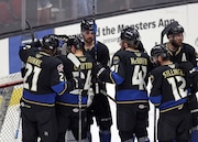 Cleveland Monsters goalie Jet Greaves and teammates celebrate after defeating the Syracuse Crunch. 