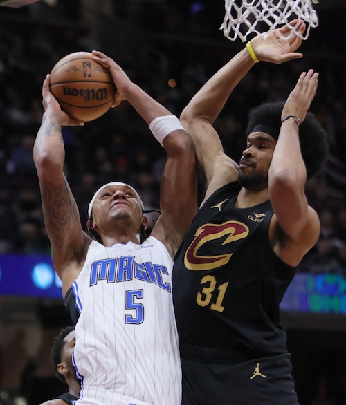 Orlando Magic forward Paolo Banchero drives towards the basket guarded by Cleveland Cavaliers center Jarrett Allen