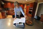 Wendy Jacobson flips through the Haggadah, a text that tells the story of the Passover tradition April 7, 2020.  Jacobson will be preparing food for Passover.  Instead of a house full of people, she will be cooking and delivering food to everyone that would have been at her house.  She will then have a virtual Passover with family.  Gus Chan, The Plain Dealer The Plain Dealer