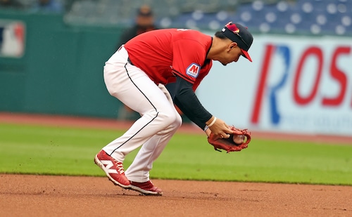 Boston Red Sox second baseman Enmanuel Valdez grounds into a double play as Cleveland Guardians second baseman Andres Gimenez snags the ball before throwing Boston Red Sox right fielder Rob Refsnyder out at second in the second inning.