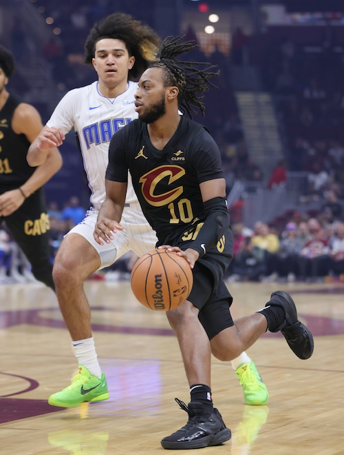 Cleveland Cavaliers guard Darius Garland drives towards the basket guarded by Orlando Magic guard Anthony Black