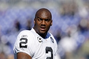 Former NFL No. 1 draft pick JaMarcus Russell was removed as an assistant football coach at his alma mater Williamson High School in Alabama after he is accused of depositing and cashing a $74,000 donation check intended for the school's football program, according to a lawsuit. (AP Photo/Rob Carr)